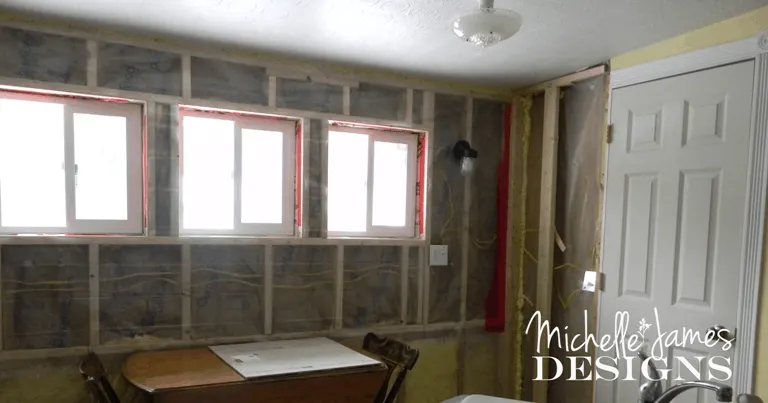 New Wall with insulation and plastic - www.michellejdesigns.com - #kitchenremodel