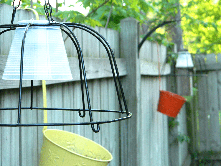 I used some dollar store hanging planters and solar lights to create some fun dollar store outdoor lighting for my back paitio! #dollarstorecrafts #dollarstorelighting #outdoorlighting #diyoutdoorlighting - www.michellejdesigns.com