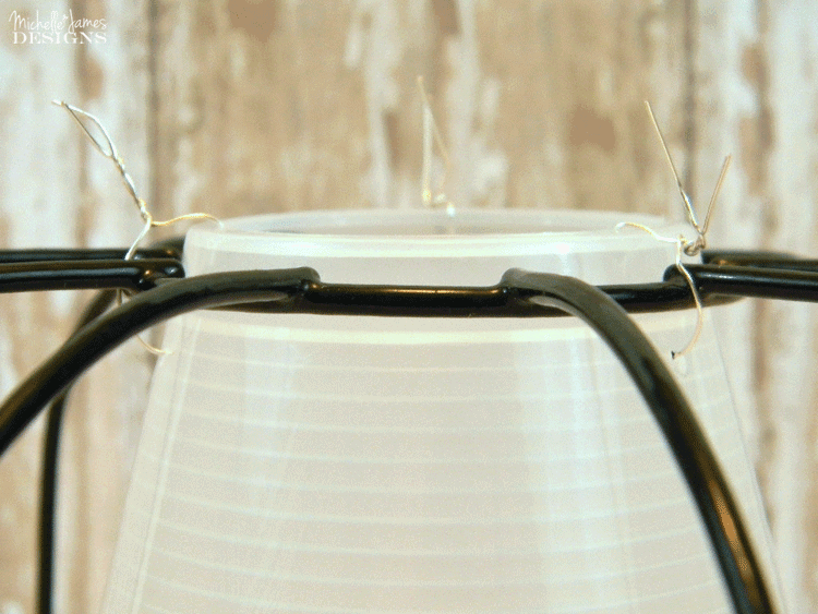 Use the wires to attached the shade to the upside down wire planter.