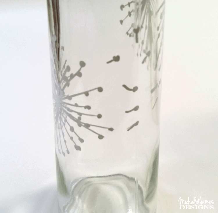 Adding flying dandelions to the outdoor solar lights made from dollar store vases.