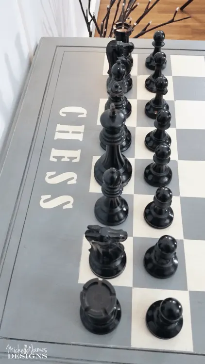 I used a HomeRight paint sprayer, some spray paint and some masking materials to paint a chess and checkers board. This was a fun DIY game table that anyone can create