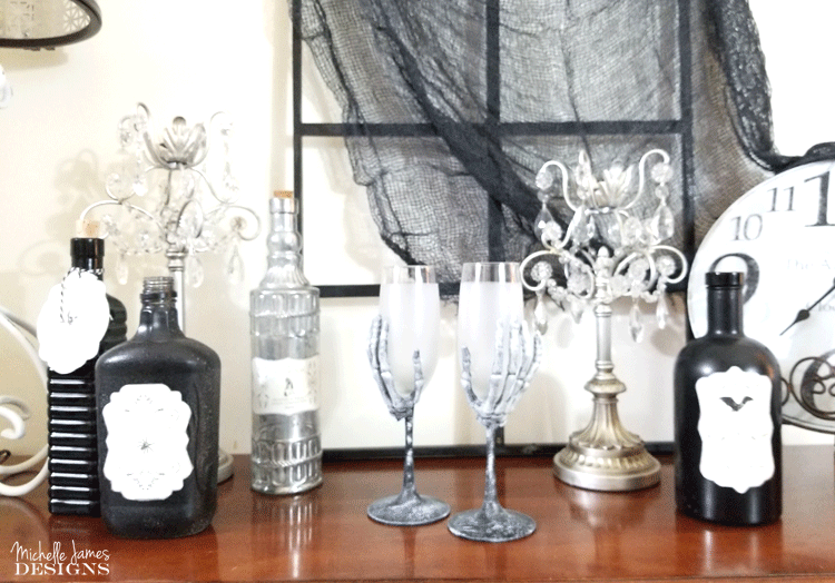 With a few supplies from the Dollar Store you are will on your way to creating some creepy skeleton wine glasses for your Halloween decor - www.michellejdesigns.com