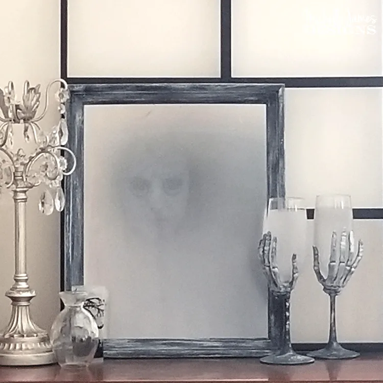 Create a haunted Halloween mirror this season. This DIY Halloween mirror will creep out your friends and family! - www.michellejdesigns.com