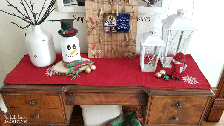 Take a look at my fun snowman mason jar craft. He is tall, festive and the perfect addition to my holiday decor. - www.michellejdesigns.com
