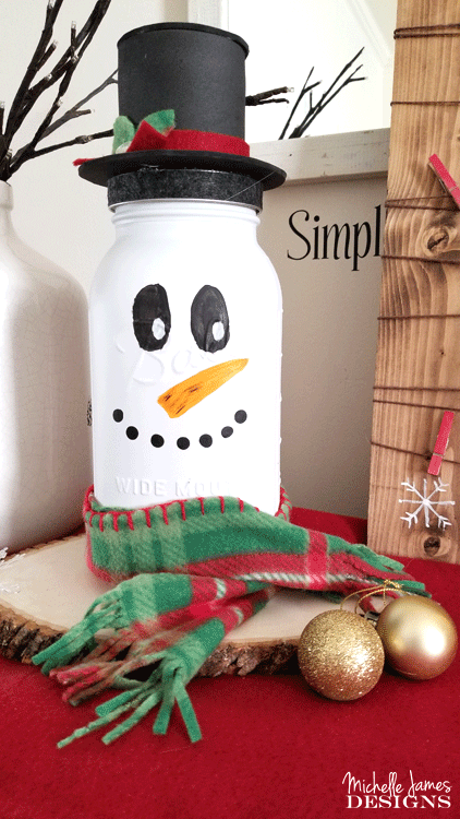 Take a look at my fun snowman mason jar craft. He is tall, festive and the perfect addition to my holiday decor. - www.michellejdesigns.com