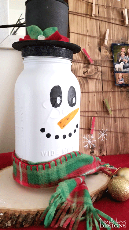 Take a look at my fun snowman mason jar craft. He is tall, festive and the perfect addition to my holiday decor. - www.michellejdesigns.com