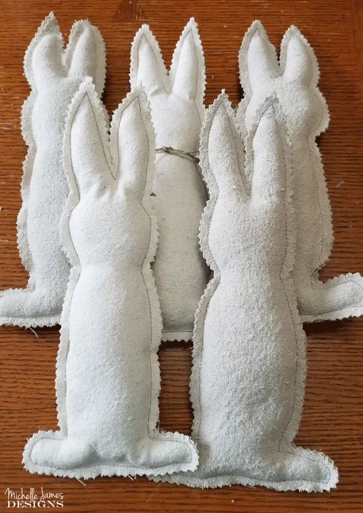 I love to create with drop cloths. They are budget friendly and give that popular farmhouse look. These drop cloth bunnies are one of my favorites! #dropcloth #dropclothprojects #farmhousestyle #bunnies - www.michellejdesigns.com