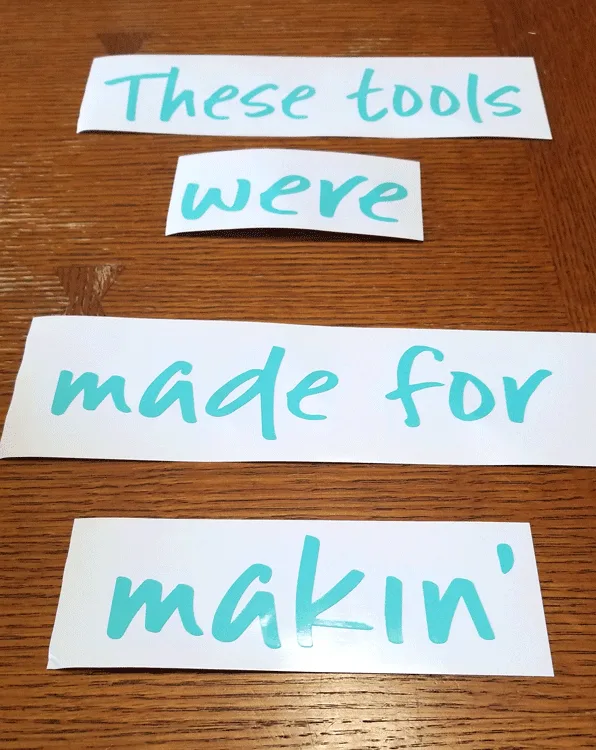 Teal vinyl pieces that read "these tools are made for makin'" to add to the sides of the white pans