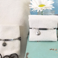 Finished bracelets and pendant necklace displayed for photos.