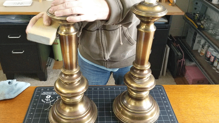 Sanding the upcycled brass lamps for painting