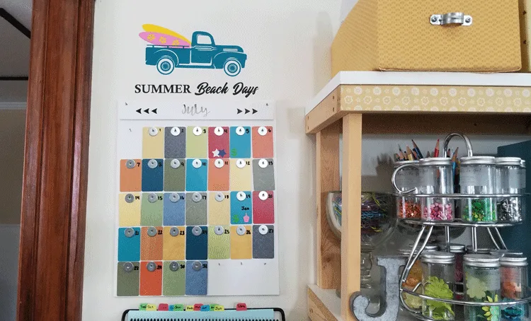Front view of the finished, colorful formica sample wall calendar with the summer seasonal vintage truck design added to the wall above it.