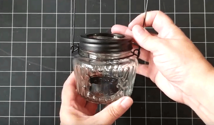 Glass tea light with black rim and tea light holder