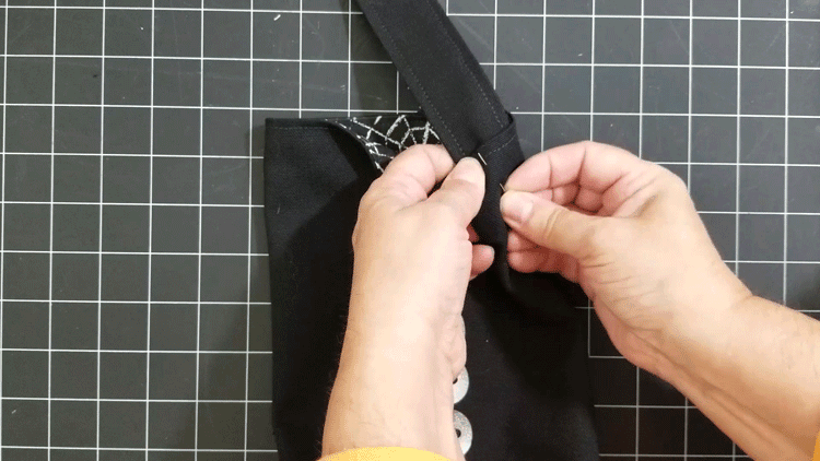 Pinning the handle onto the wine bag for stitching.