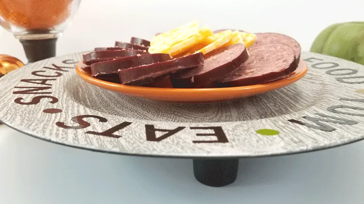 Finished plastic charger plate buffet tray with meat and cheese.