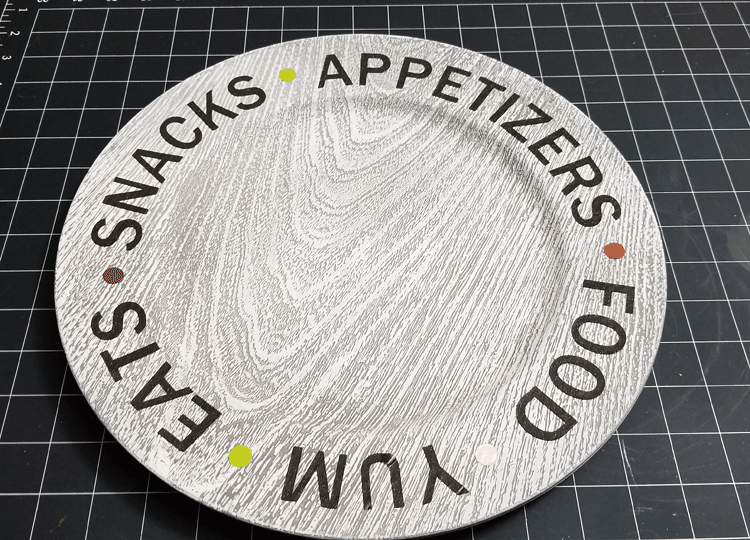 Plastic charger plate with the text design around the outer edge