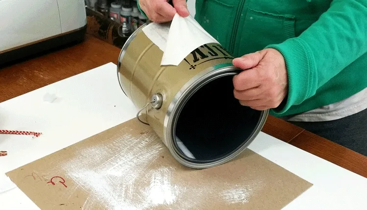 Adding vinyl design to front of paint can