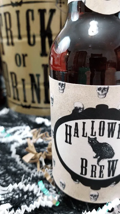 Finished Trick or Drink Halloween bucket and four beer bottles with Halloween printable labels.