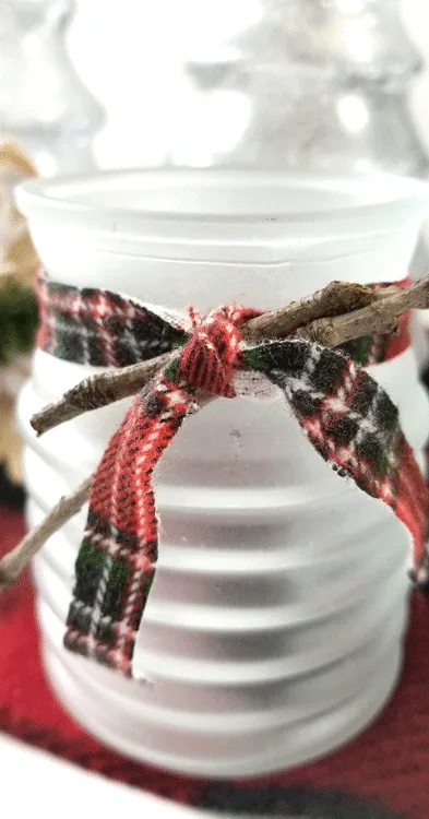 Finished frosted glass tea light candle holder with red plaid flannel fabric ribbon.