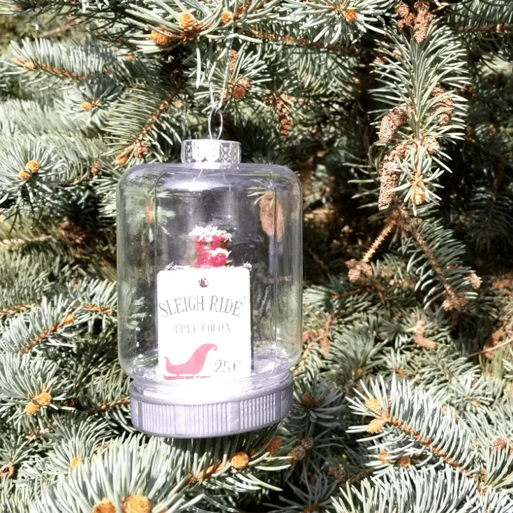 Dollar Tree mason jar ornament hanging on a tree.