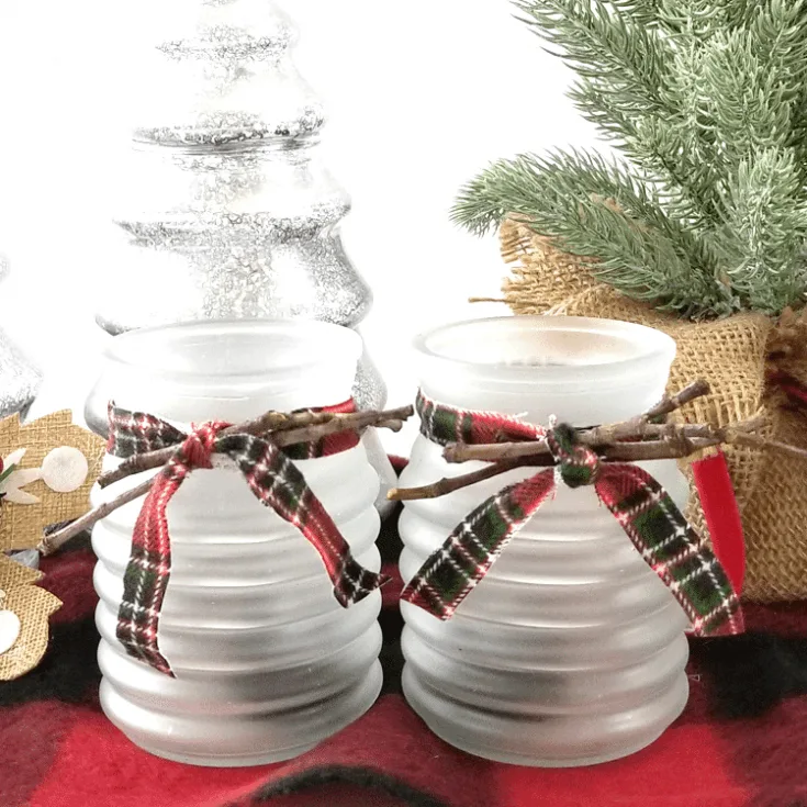 Finished frosted glass tea light candle holder with red plaid flannel fabric ribbon.