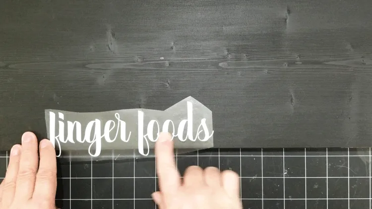 Figuring out where to place the words "finger foods" on the wood tray