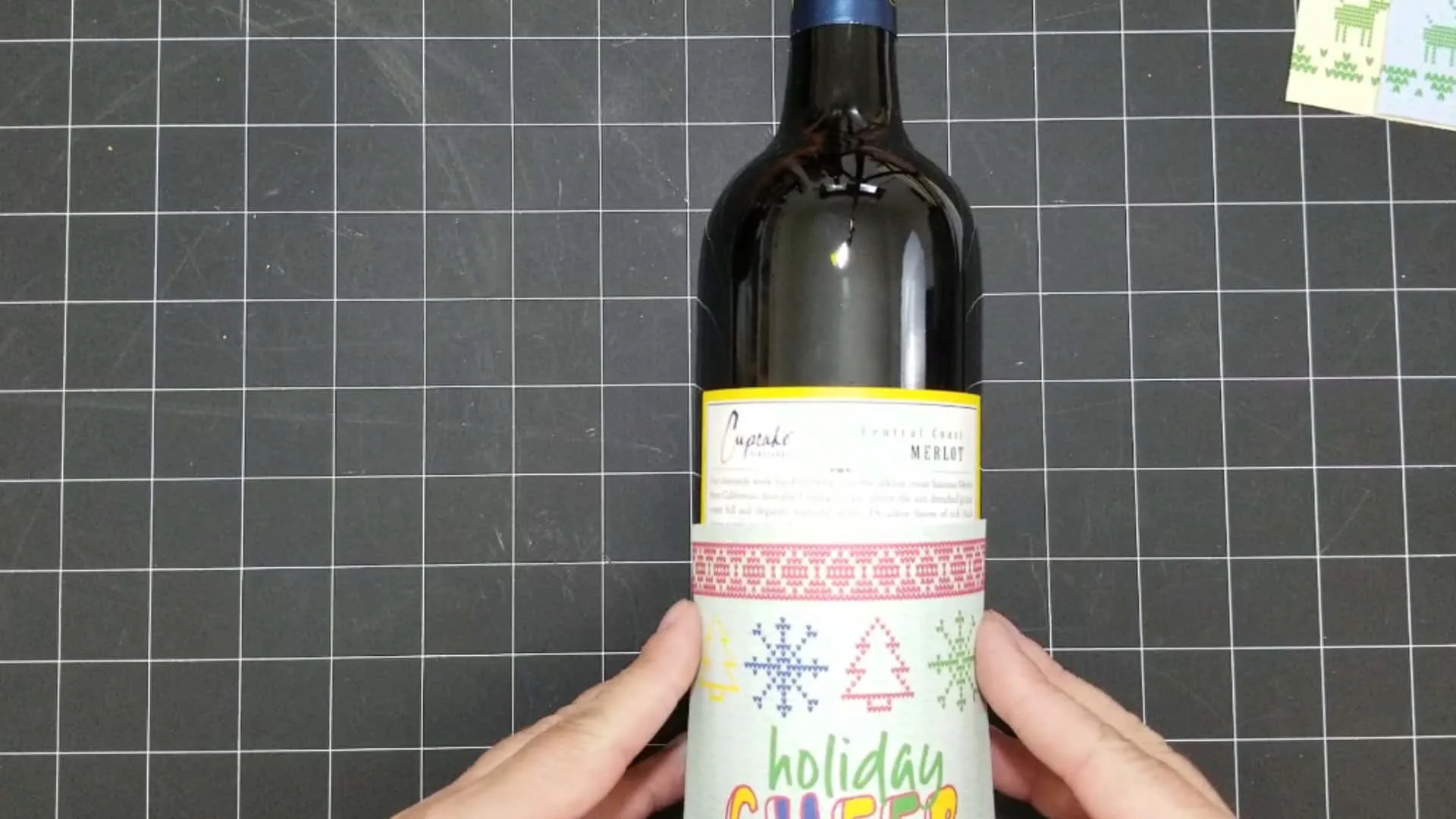Figuring out just where to place the holiday wine label onto the bottle.