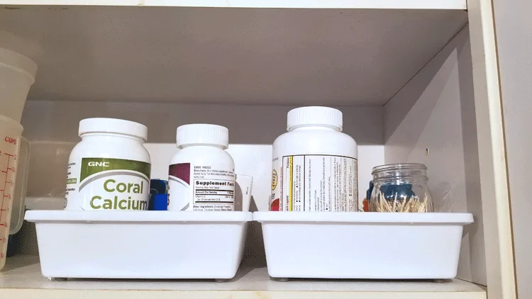 Dollar Store drawer trays to organize meds in cupboard