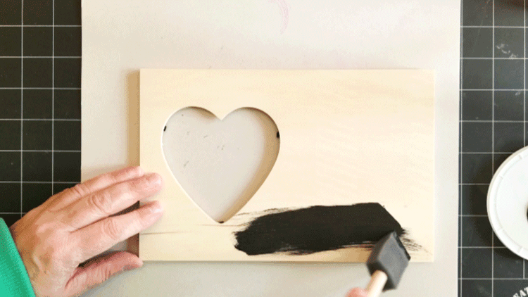 Painting the wood frame with black paint.