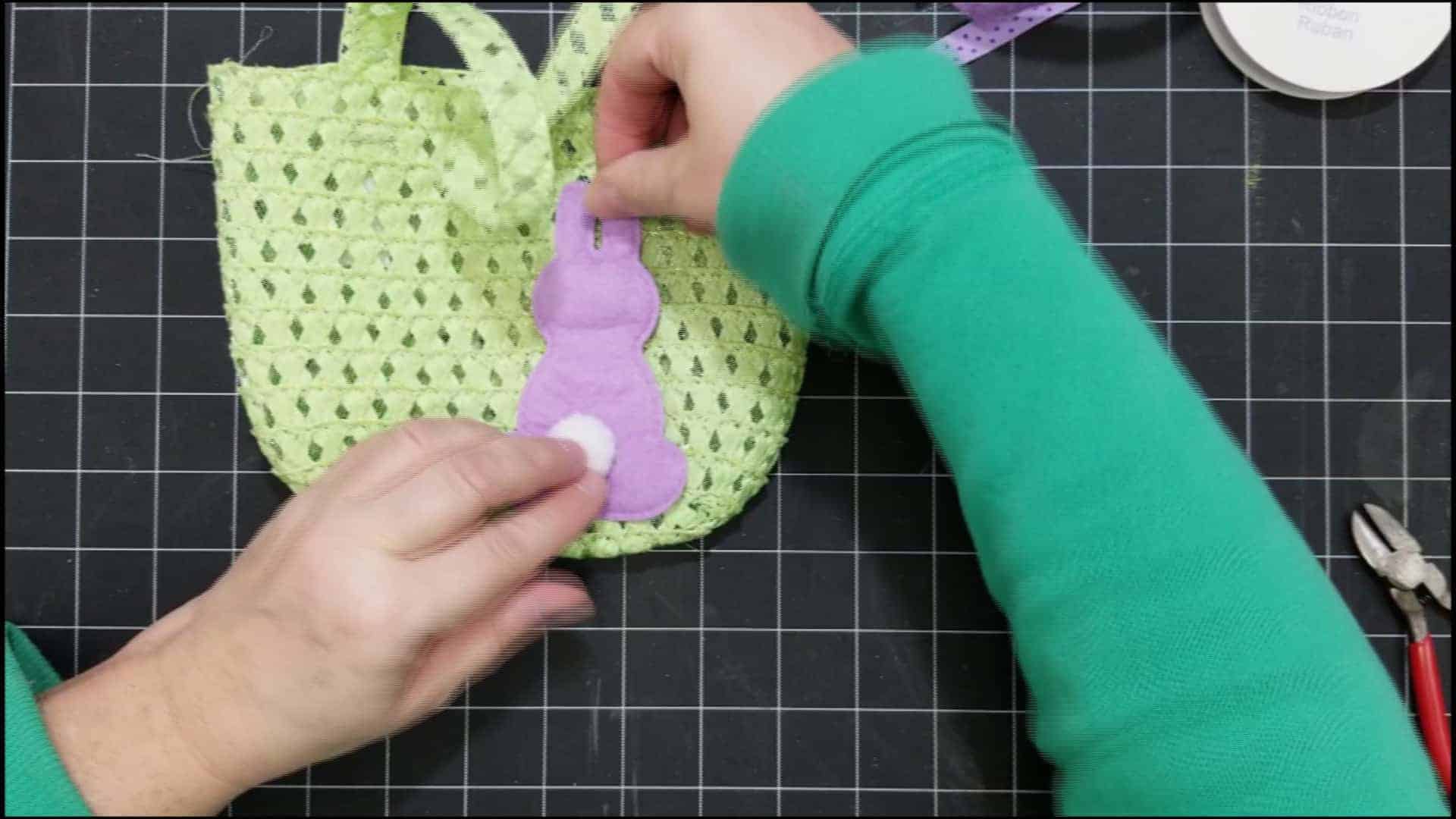 Placing the bunny face down onto the little purse basket.