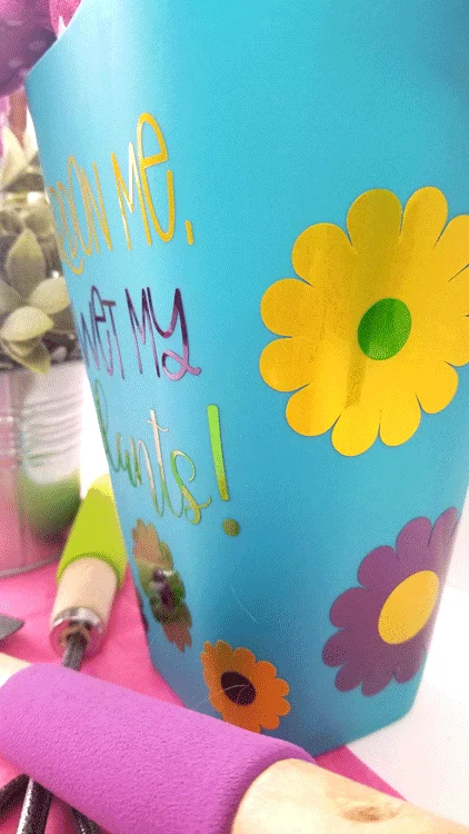 Adding vinyl text to the Dollar Tree watering can for a garden gift basket.