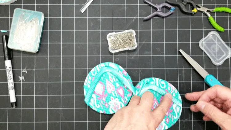 Using pins to attach the plastic straps to the Dollar Tree Flip Flop Coasters