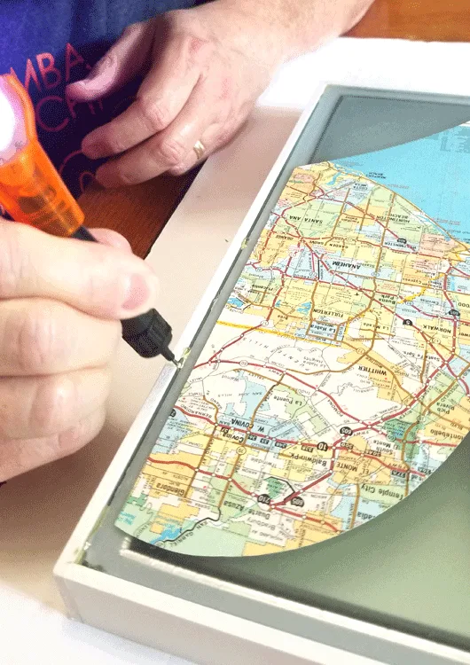 Squeezing out the glue from the Bondic glue pen with ultra violet light.