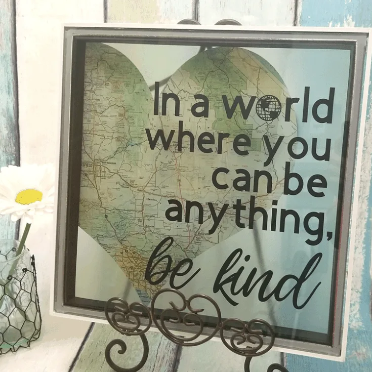 Finished piece of diy kindness art displayed on an easel.