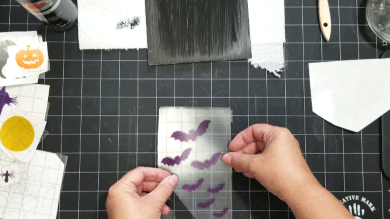 Adding the purple transparent bats to one side of the candle holder