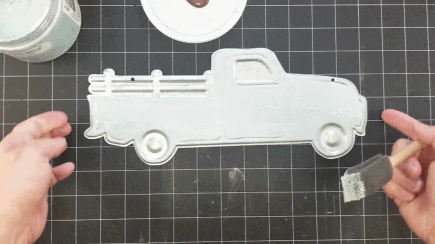 Painting the metal truck using a white wash painting technique using the Vintage color.