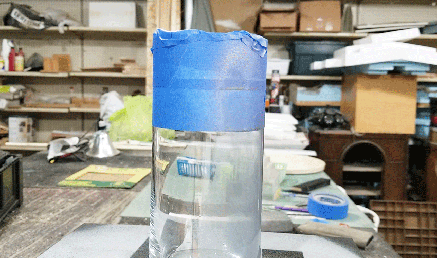 Spraying the first bit of looking glass paint onto the glass vase