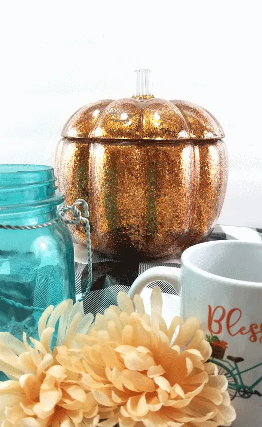 Finished glitter orange glass pumpkin with buffalo check and teal.  The perfect fall decor.