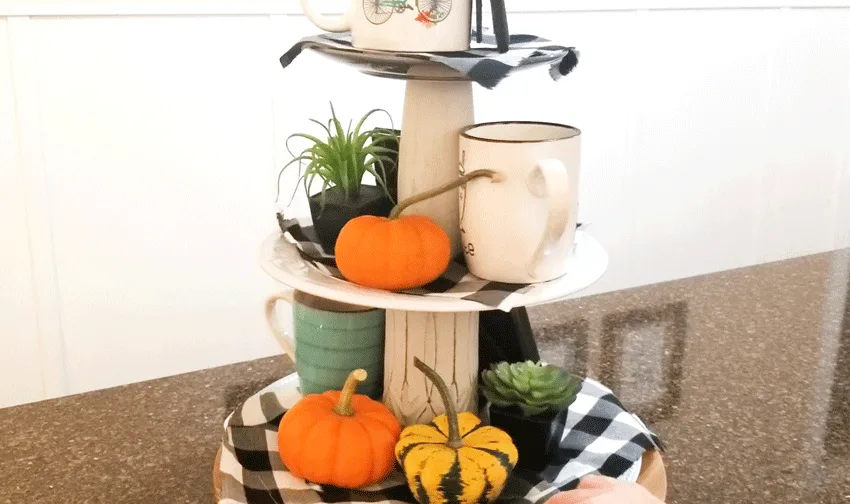 Adding pumpkins as filler to the back of the tiered tray