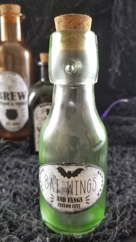 The green bottle up close with the grunged up label