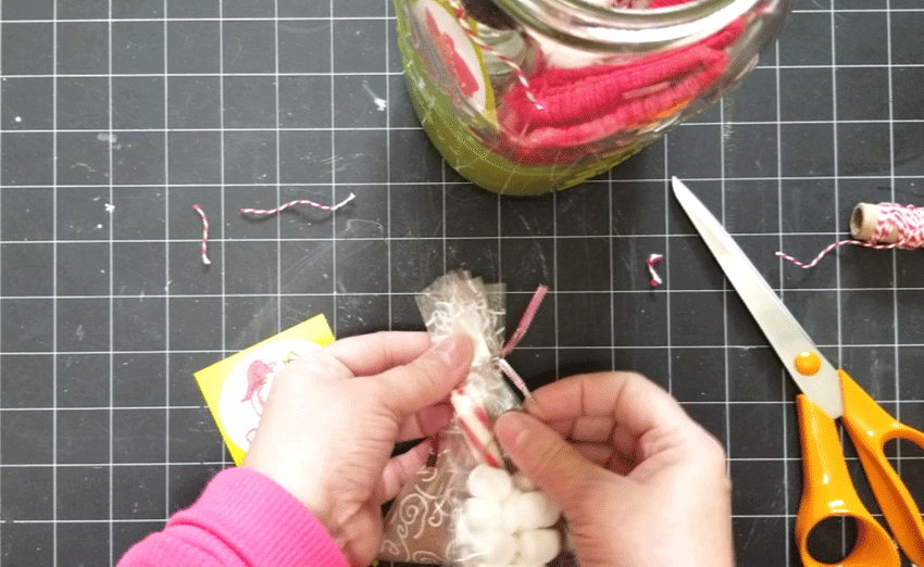 Adding a tag to the marshmallows and peppermint stick.