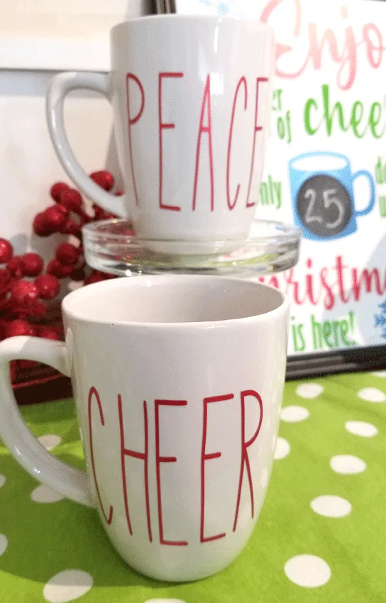 close up picture of Cheer mug and Peace mug with the countdown sign in the background
