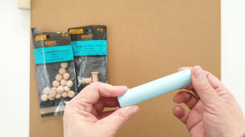 The spray painted dowel piece in light blue.