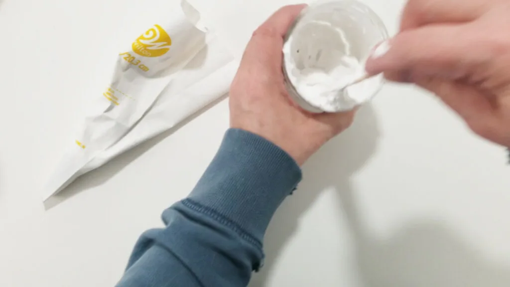 Adding the spackle to a cake decorating pastry bag with a star tip.