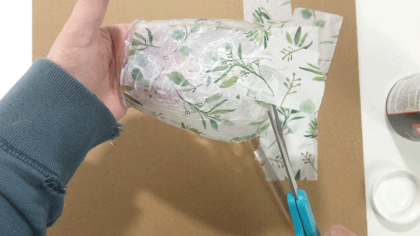 Using scissors to cut the folds to lay them flat.