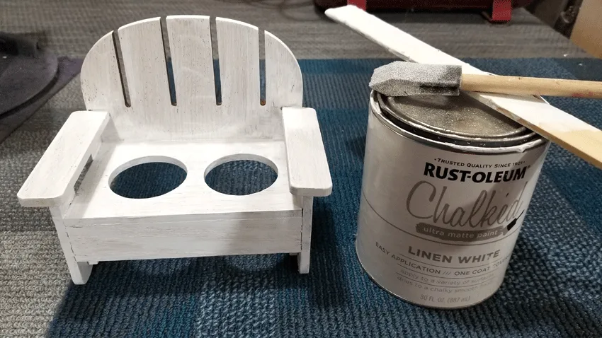 Using Rustoleum Chalked paint in Linen white to paint the cute wood bench that will hold the planter vases.