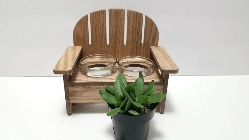 Wood small bench with glass votive holders and a small succulent plant