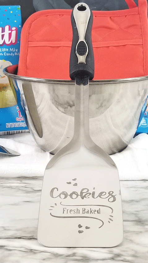 Etched metal cookie turner spatula that reads "cookies fresh baked"