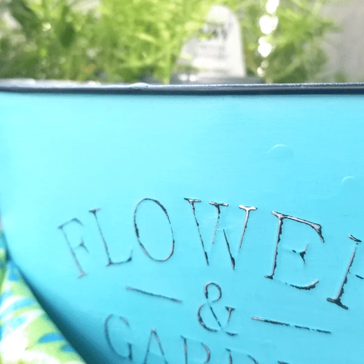Close up of the finished distressed metal with chalk paint flower container