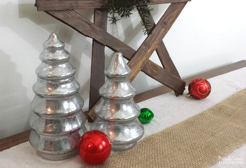 Faux mirror glass trees in front of the wooden star