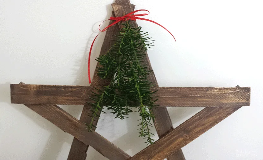 A close up pic of the top of the diy wood star to show the greenery.